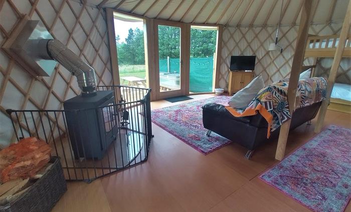Luxury Yurt, with wood burner, sofa, bunk beds, king size double bed, smart TV and stunning country views through the full height window